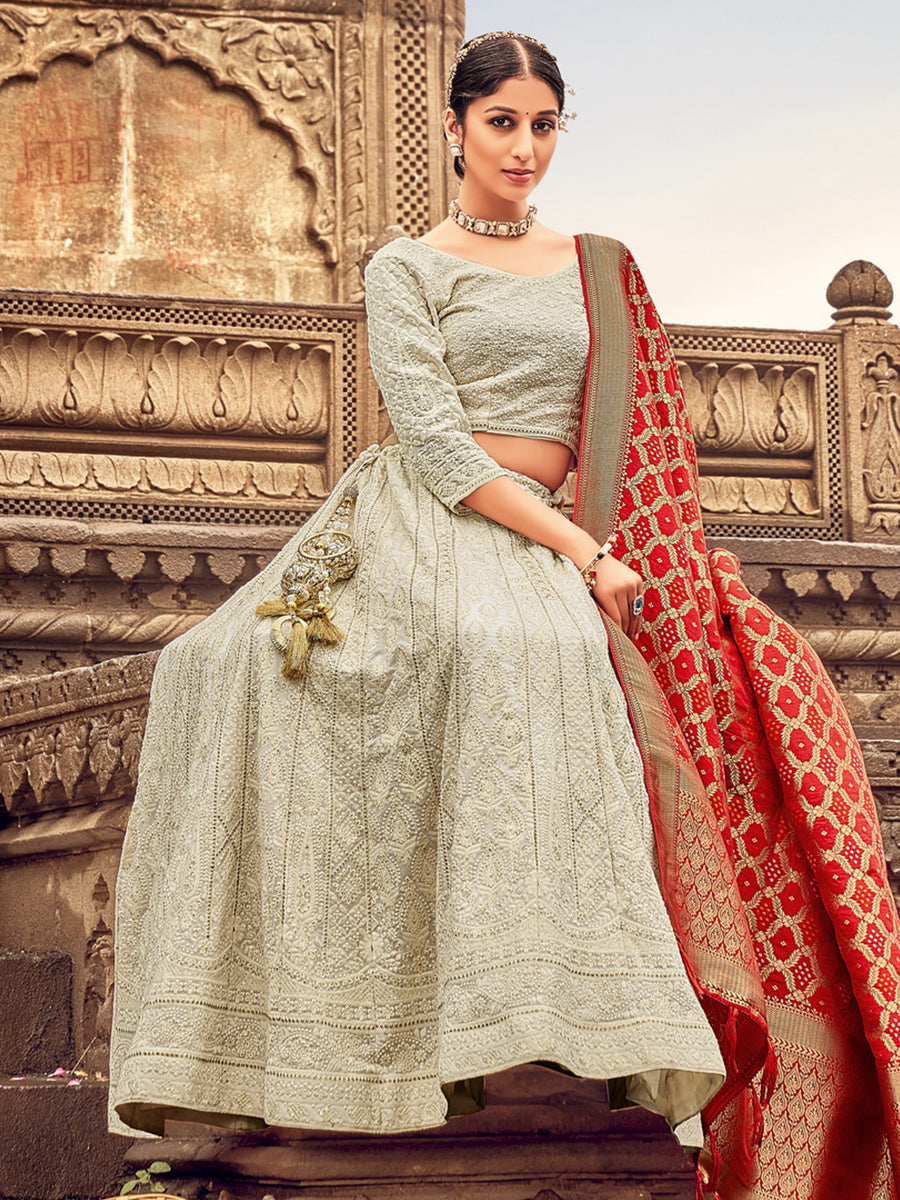 IVORY WHITE COLOURFUL BANARASI LEHENGA SET WITH A MULTI COLOURED  EMBROIDERED BLOUSE PAIRED WITH A SHADED BANARASI DUPATTA AND SILVER  DETAILS. - Seasons India